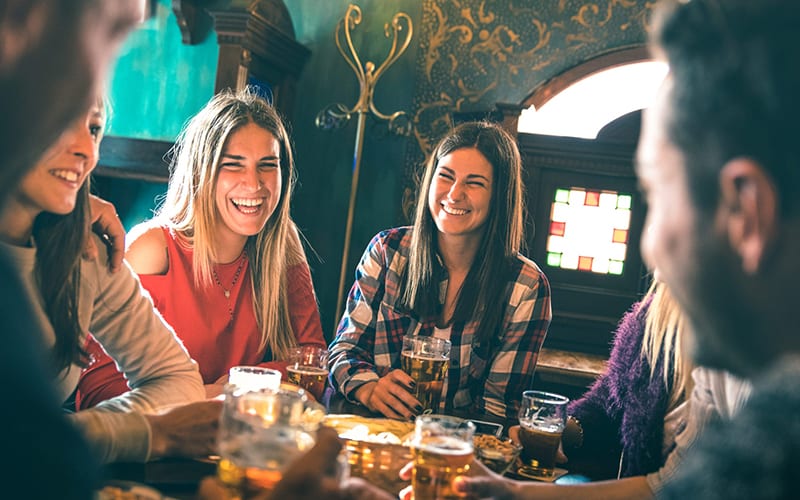 Friends laughing over beer in Raleigh, NC