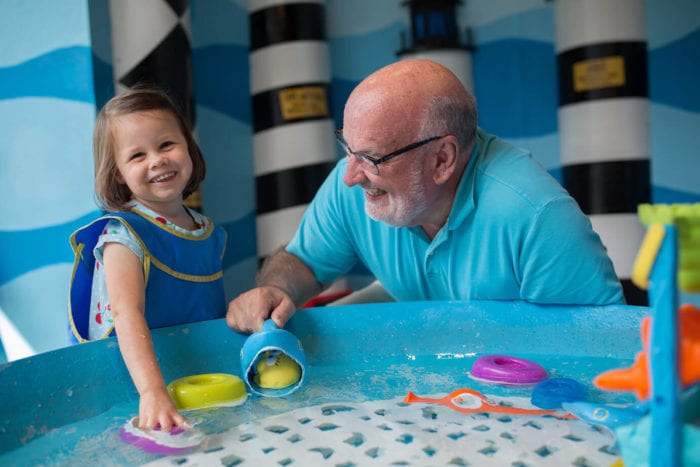 A child and her grandfather enjoying the Marbles Kids Museum - museums in Raleigh NC