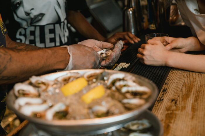 Tour group enjoying oysters in Raleigh, NC as part of a food tour
