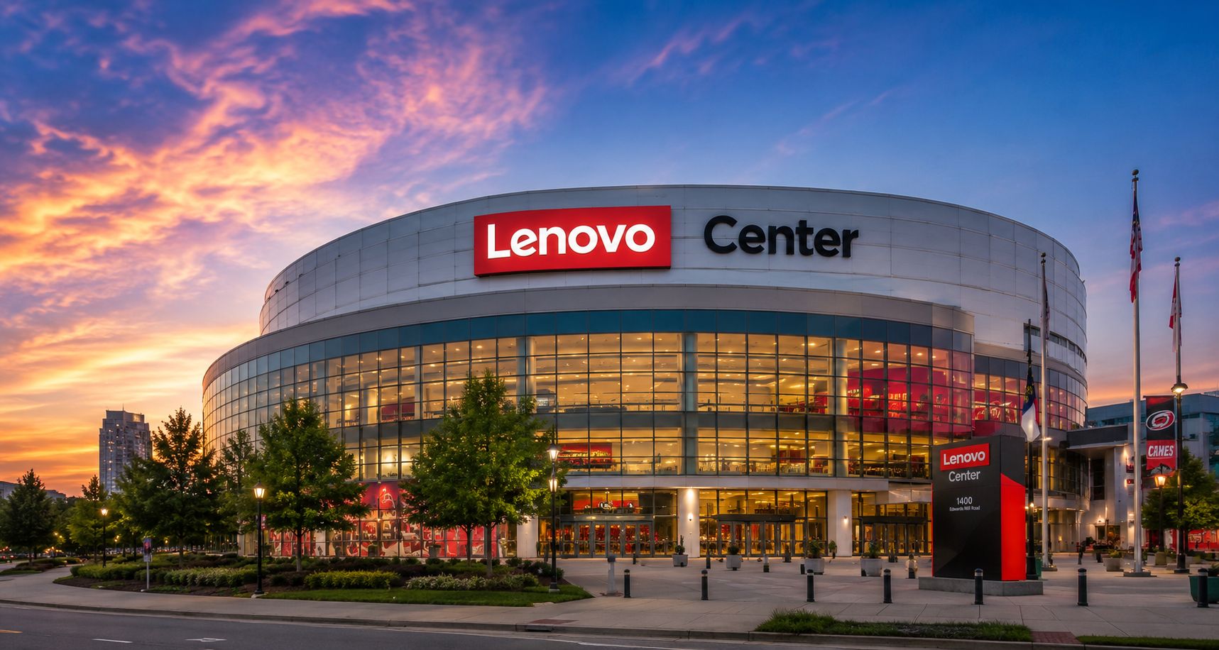 Exterior view of the Lenovo Center in Raleigh, North Carolina at sunset, with the illuminated arena facade and entrance visible before a concert or sporting event.